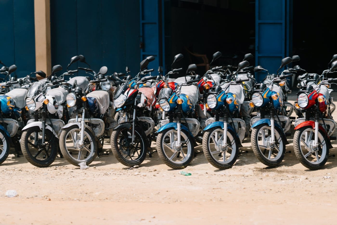 Rows of electric motorcycles ready for fleet deployment