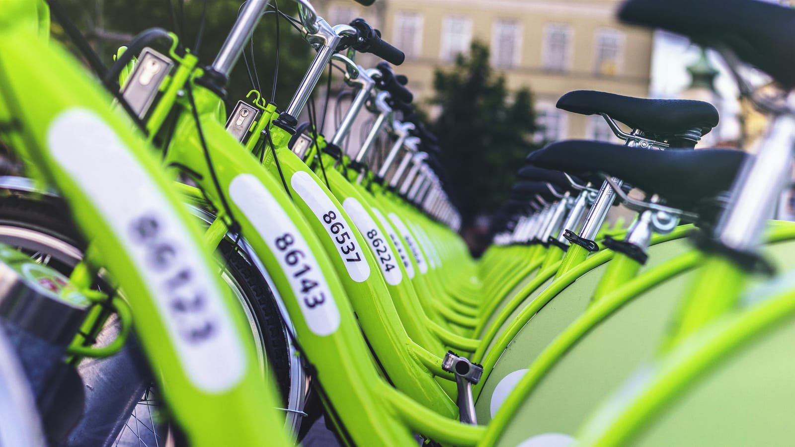 Row of shared electric bikes docked in a city
