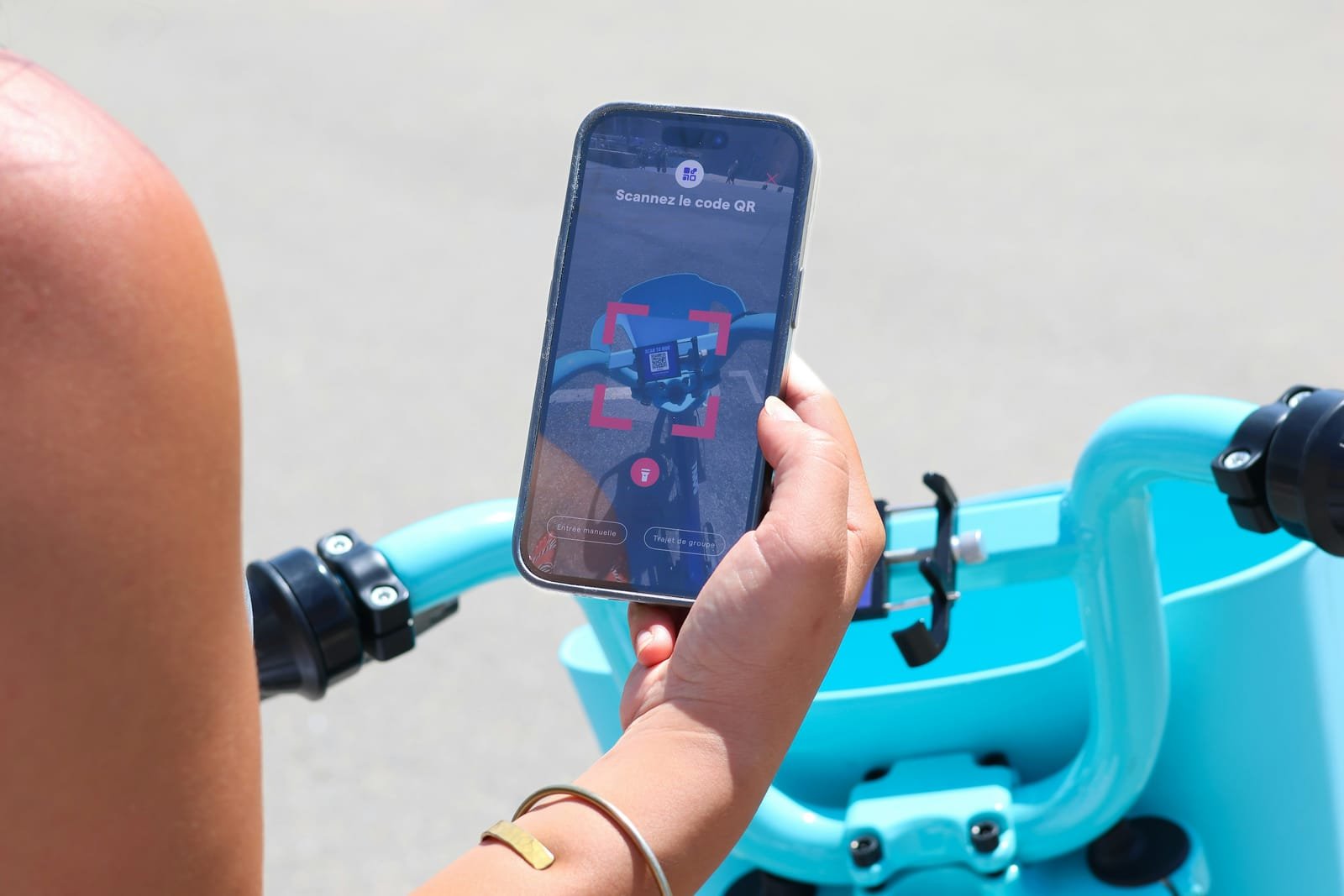 Rider scanning a QR code to unlock a shared vehicle from their phone